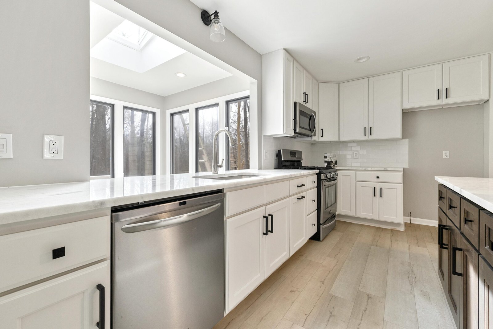 Bright contemporary kitchen with sleek stainless steel appliances and ample natural light.